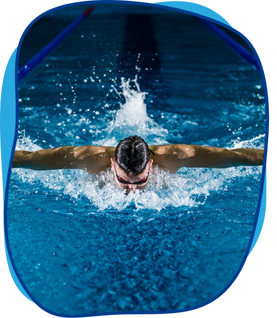 Competitive butterfly swimmer in swimming pool lane