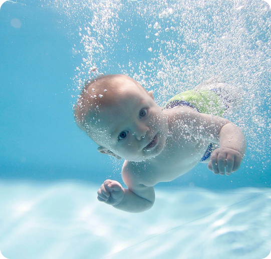 Baby Swimming with Friendly Dolphin
