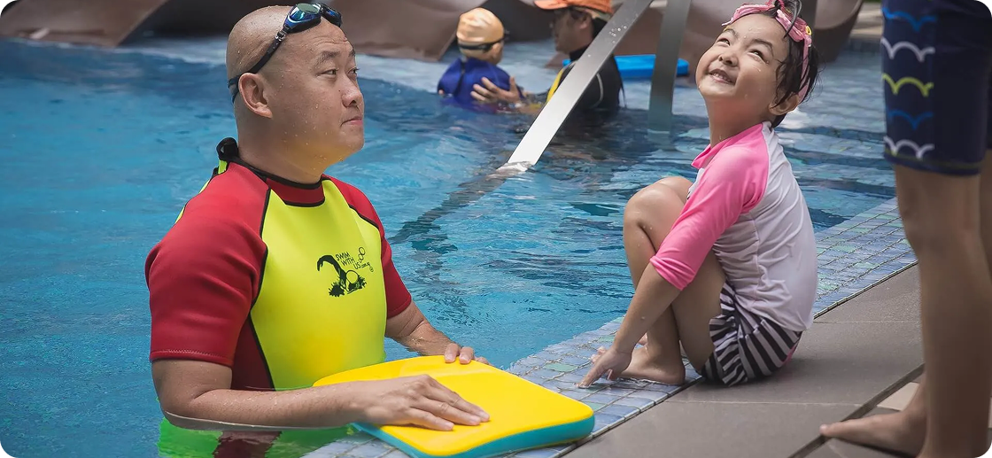 Swim instructor and student smiling during lesson