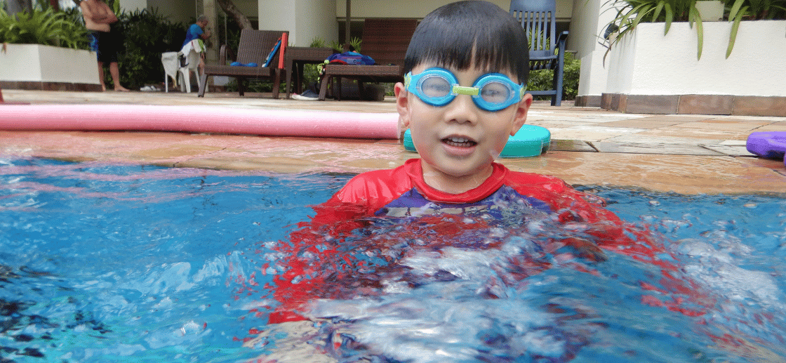 Baby swimming underwater with bubbles