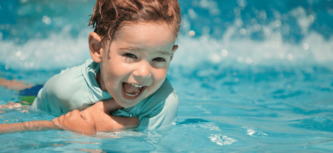 Baby swimming underwater with bubbles