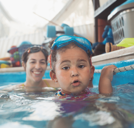 Toddlers Swimming with Friendly Dolphin