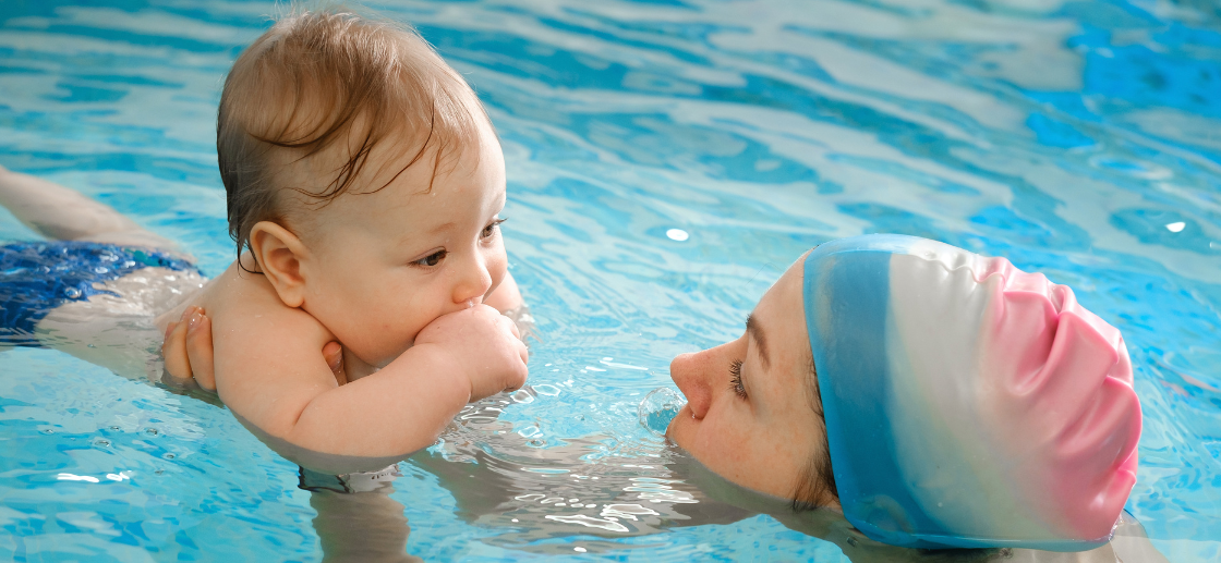 Baby swimming underwater with bubbles